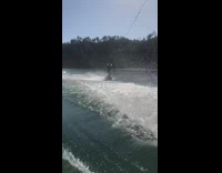 Guy falls off wakeboard brown white boat