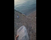 Woman throws brick to water and float