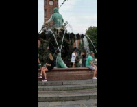 Girl white shirt hat water fountain statue