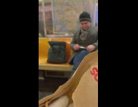 Guy cutting his own nails with scissors on subway