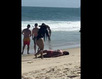 Kid throw sand over woman lay on beach