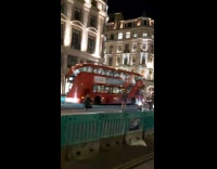 Girl walks middle of street dress bus 