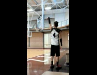 Guy shoots ball from behind the backboard 