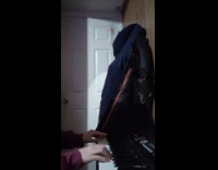 Boy plays original piece with piano keyboard