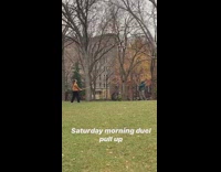 Two guys duel with wood sticks park 