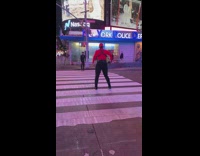 Three guys film dance video in middle of crosswalk 