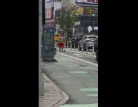 Guy kicks green soccer ball down street