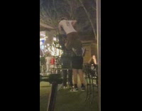 Group of friends stack chairs and sits on top