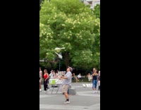 Man grey shirt juggle pins at park