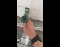 Guy open upside down urinal faucet water