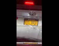 Damaged car with ITS OVER license plate