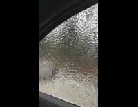 Guy shatters ice on car window 