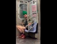 Halloween aftermath guy green hair rides subway 