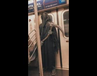 Guy with grim reaper costume rides subway 