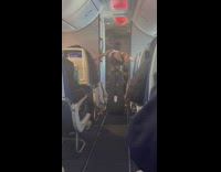Two women yoga pose on the airplane aisle