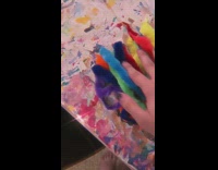 Girl hangs colorful feathers around room laptop