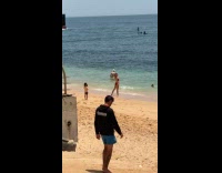Kid pictures woman in bikini at beach