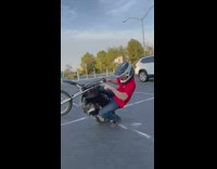 Guy does a wheelie in a circle 