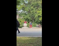 Pink leggings girl sits poses concrete ball 