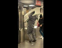 Man tries to carry car bumper through subway gate