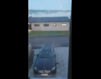 Guy looks out window fog over neighborhood 