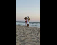 Man and woman dance rap video drone beach
