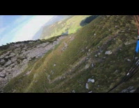 Guy green parachute flies over mountain hills