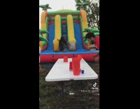 People play drinking game with bounce house slide