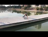 Woman black top yoga mat wooden bridge