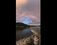 Man films rainbow over lake 