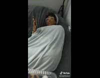 Guy brings cake to woman in beanbag 