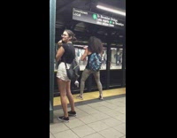 Man plays air drums, sings and yells at subway station