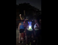 Woman poses fountain beside runners prepare run