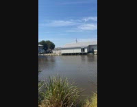 House boat pushed by barge on water