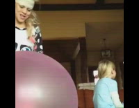 Little girl long sleeve blue shirt hit with big red balloon knocked out by sister girl