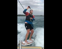 Guy shotguns beer on white wakeboard boat 
