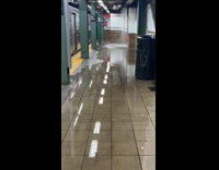 Rain water floods the subway station platform