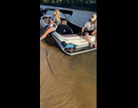 Dog in blue life vest jumps off boat