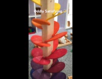 Ball dropped on wooden toy produces sound