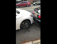 White car parallel parks between cars fail 