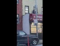 Young girl on top of red store sign