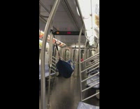 Man sets up blue hammock in subway train