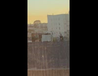 Guy black cape still dance rooftop sunset