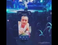 Woman facetiming man smoking shisha at a concert
