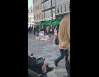 Dance group in white and pink outfit on the street
