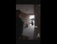 Guy trips walking to front door of home with baby 