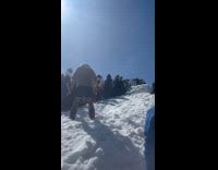 Collab Scorpionmasters - Guy purple shirt ski flip on the ramp while other people watch on the side