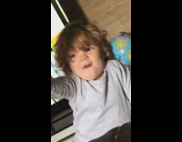 Little boy points shoots toy black gun