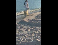 Woman white dress squat on table beach