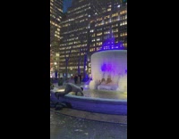Homeless man digs for coins in a fountain in freezing temperatures